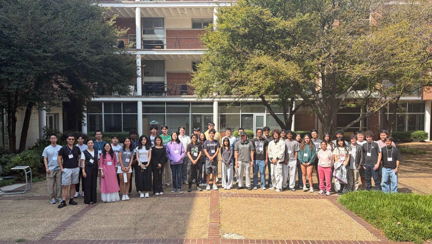Bootcamp participants and
              organizers standing together in the courtyard outside the Skiles
              Classroom Building at Georgia Tech